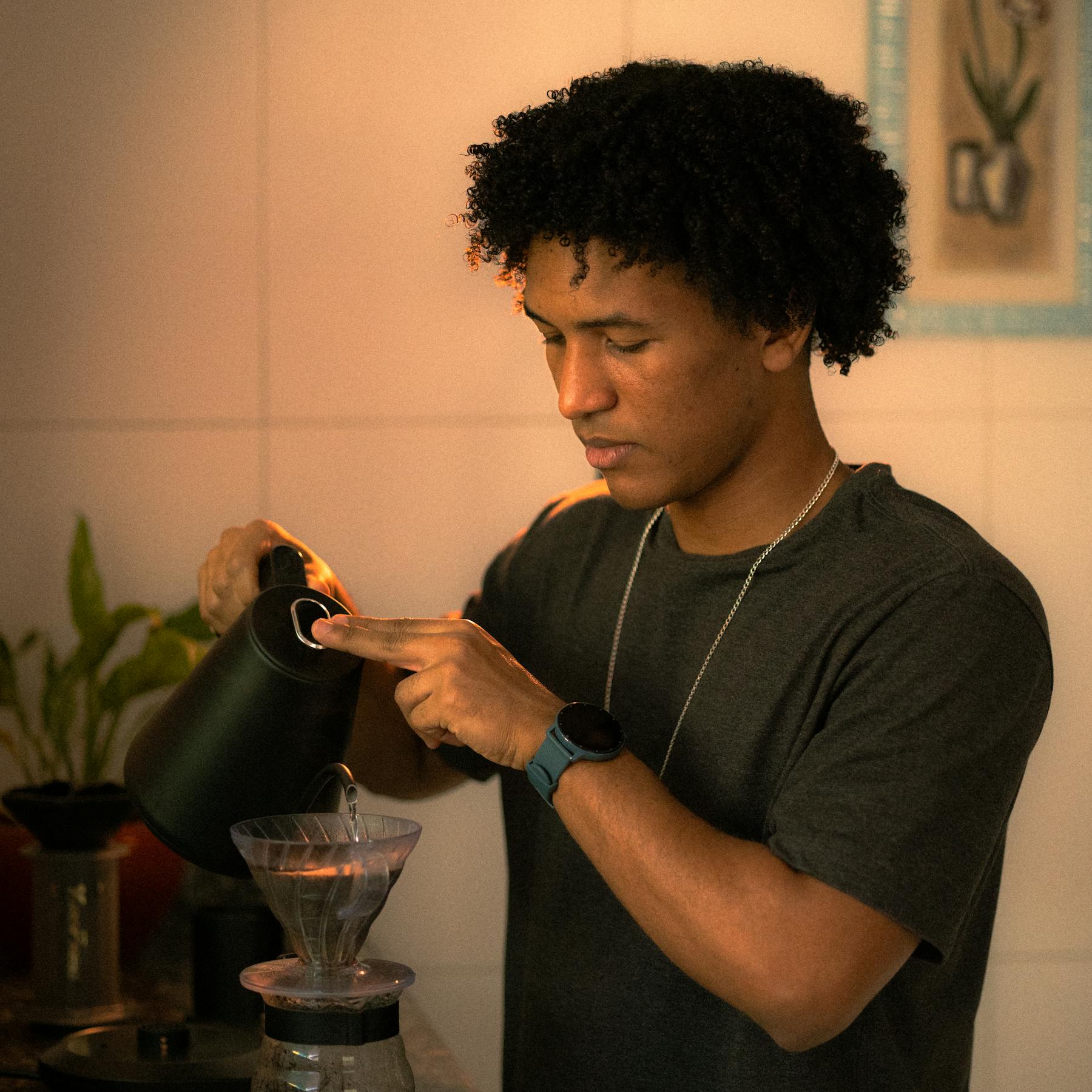 A barista brewing pour-over coffee